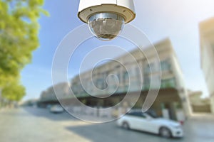 CCTV Security camera with townhome on background photo