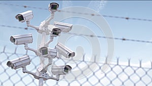 CCTV secutity cameras system and barbed wire fence. Privacy, security and protection