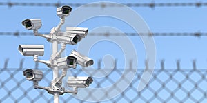 CCTV secutity cameras system and barbed wire fence. Privacy, security and protection concept