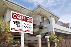 CCTV sign in front of a gated home. Warning to visitors or burglars. Security system and protection in a residential home