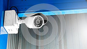 CCTV surveillance security camera inside of factory building for safety system area control indoor with flare light and copy space