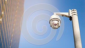 CCTV surveillance security camera on pole in city for safety system area control outdoor with flare light effect and copy space