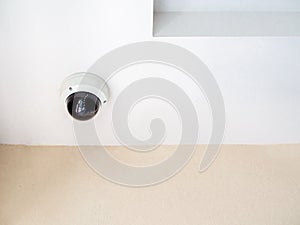 CCTV system security. Round CCTV camera on ceiling in the corner of the walkway in condominium
