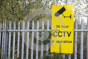 CCTV yellow sign on security railing