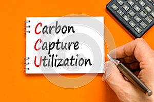 CCU Carbon capture utilization symbol. Concept words CCU Carbon capture utilization on beautiful note. Beautiful orange background