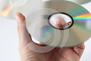 Cd compact disc in the hand on white background