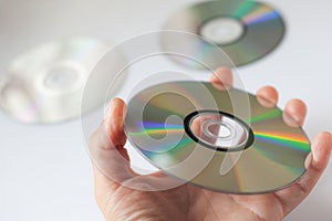 Cd compact disc in the hand on white background
