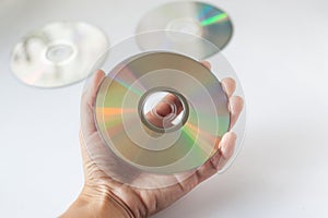 Cd compact disc in the hand on white background