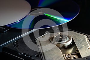 CD on the computer notebook cd rom in darkness.