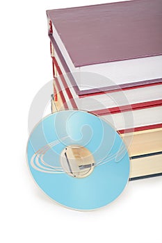 Cd-rom disk and pile of books