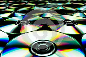 CDs / DVDs lying on a black background with colorful reflections of light. photo