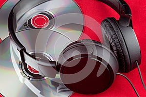 CDs and Headphones on a Red Background