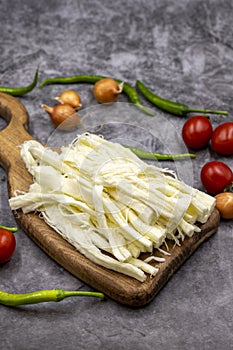 Cecil cheese or String cheese on a dark floor. Delicious assortment of cheeses