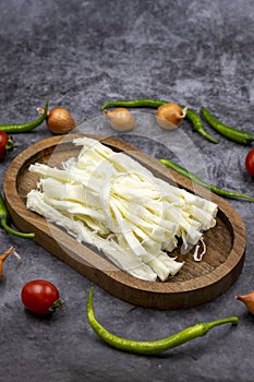 Cecil cheese or String cheese on a dark floor. Delicious assortment of cheeses