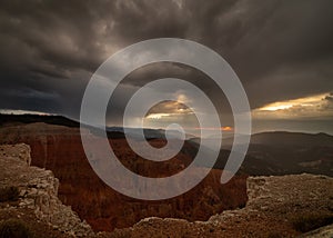 Cedar breaks amphitheater under dark stormy skies at sunset