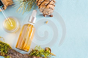 Cedar essential oil, pine in a glass green bottle with a pipette. Flat lay, minimalism The concept of natural cosmetics