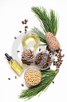 Cedar oil, branches and cedar cone on white. Copy space. Beauty and healthy concept