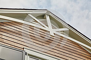 Cedar Shake Siding and Gable Struts Against Blue Sky