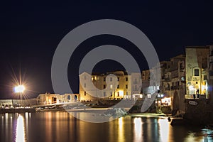 Cefalu at night, Sicily, Italy. Seascape, cityscape. View on harbor and old houses. September 2019
