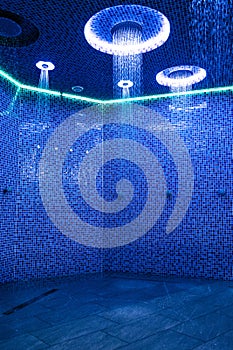 Ceiling in a blue shower room with dynamic LED lighting vertical