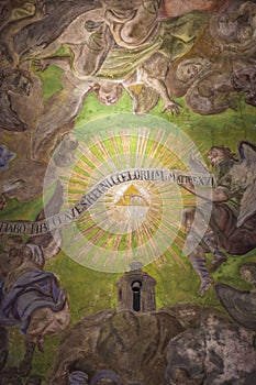 Ceiling of the cathedral with ancient paintings and the name of God, Jehovah tetrogramaton, YHWH in the very center. photo
