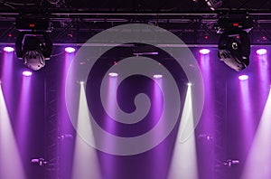 The ceiling of the concert stage with purple and white spotlights on the stage farm