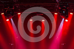 The ceiling of the concert stage with red and white spotlights on the stage farm