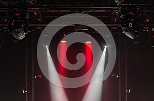 The ceiling of the concert stage with red and white spotlights on the stage farm