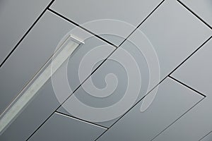 Ceiling covered with smooth white panels with a lamp