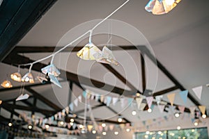 Ceiling decoration with paper flags and lightbulbs