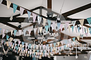 Ceiling decoration with paper flags and lightbulbs for birthday