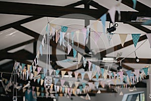 Ceiling decoration with paper flags and lightbulbs