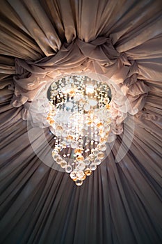 Ceiling drape and sparkling chandelier near the center area