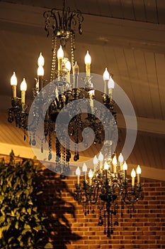 Ceiling gilded chandelier in classic interior