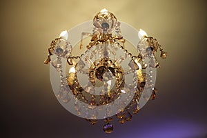 Ceiling gilded chandelier in classic interior