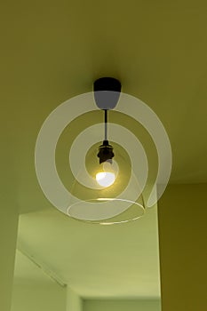 Ceiling lamp in the apartment in yellow light