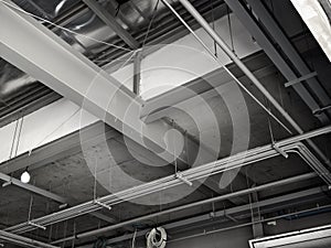 The ceiling of a large building under construction an extensive network of pipes