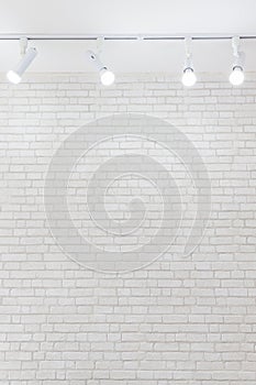 Ceiling light on white brick wall texture background with copyspace.