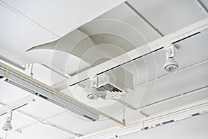 Ceiling mounted cassette type air condition units with other parts of ventilation system tubes, cables and vents located inside