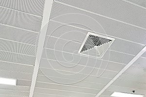 Ceiling mounted cassette type air conditioner and modern lamp light on white ceiling. Duct air conditioner for home, hall or