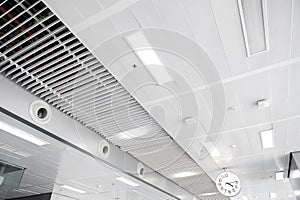 Ceiling mounted cassette type air conditioner and modern lamp light on white ceiling. duct air conditioner for home or office