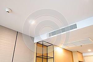 Ceiling mounted cassette type air conditioner and modern lamp light on white ceiling. duct air conditioner for home or office