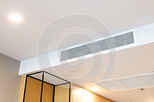 Ceiling mounted cassette type air conditioner and modern lamp light on white ceiling. duct air conditioner for home or office