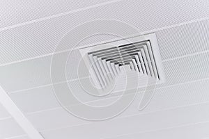 Ceiling mounted cassette type air conditioner and modern lamp light on white ceiling. duct air conditioner for home or office