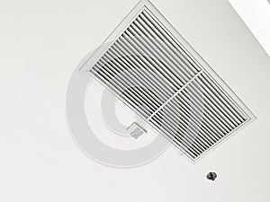 Ceiling mounted cassette type air conditioner and modern lamp light on white ceiling. duct air conditioner for home or office