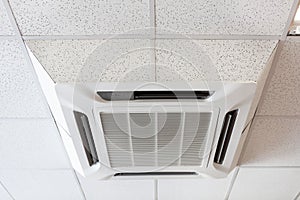 Ceiling mounted large air-conditioner in office, close-up view photo