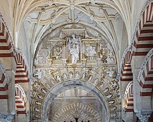 Ceiling and Muslim arch with Christian reliefs in the Hypostyle Prayer Hall of the Mosque-Cathedral of Cordoba in Spain.