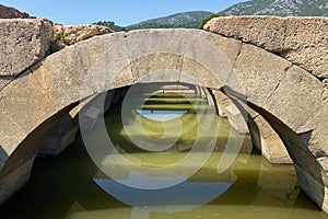 Ceiling ruins of ancient stone temple of Apollon in Klaros ancient city filled water photo