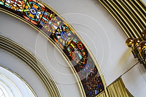 Ceiling of a semicircular form of the Soviet building with curved and multi-colored stained-glass windows. Old architecture.