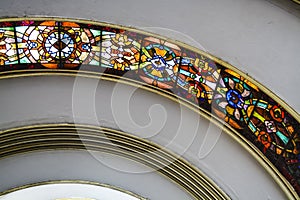 Ceiling of a semicircular form of the Soviet building with curved and multi-colored stained-glass windows. Old architecture.